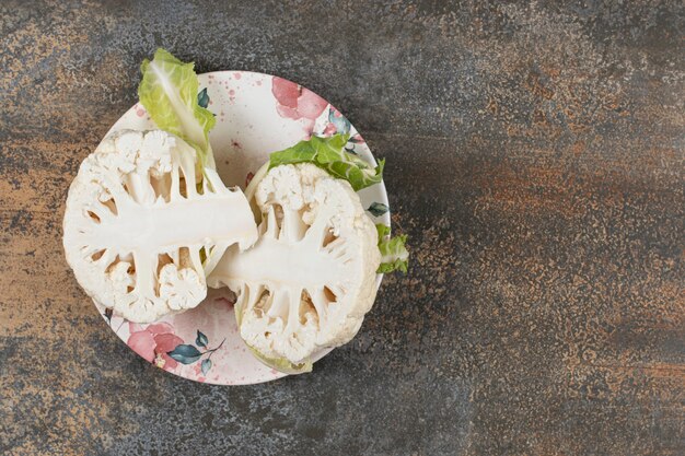 Free photo three radish on the plate , on the marble surface