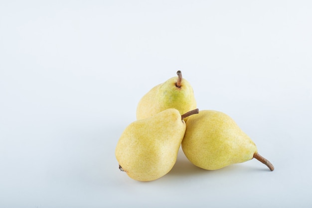 Three ripe pears on white background. High quality photo