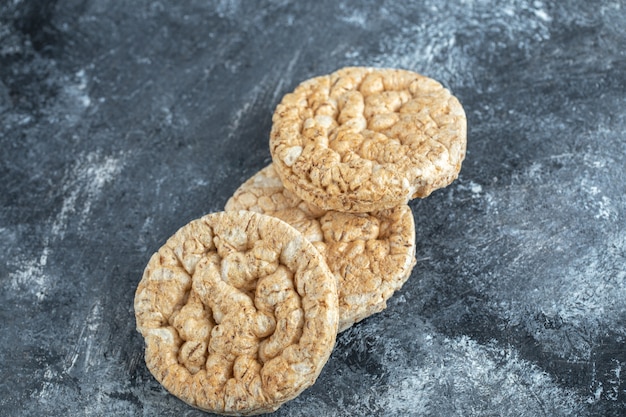 Three round crispbread on marble.