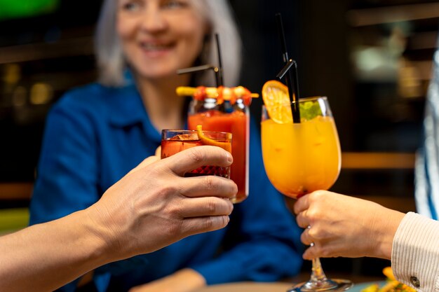 Three senior friends drinking at a restaurant