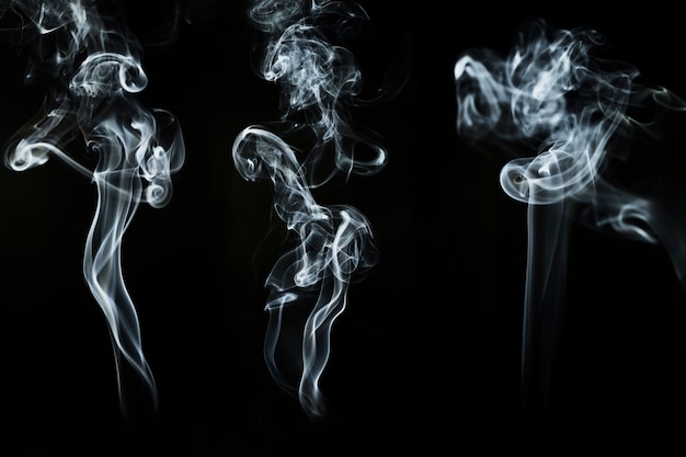 Three silhouettes of smoke in motion