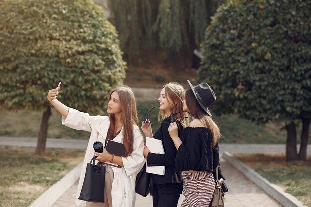 Three students standing in a university campus