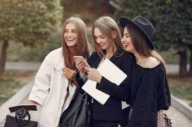 Three students standing in a university campus