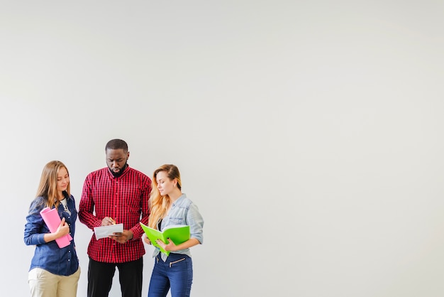 Three students watching notes