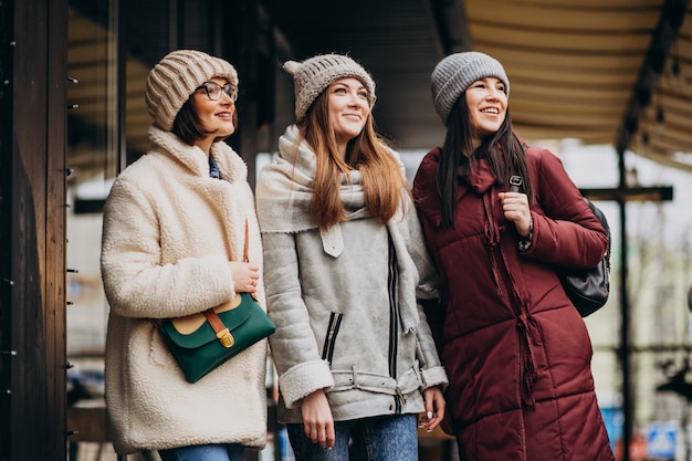 Three students in winter outfit at the street