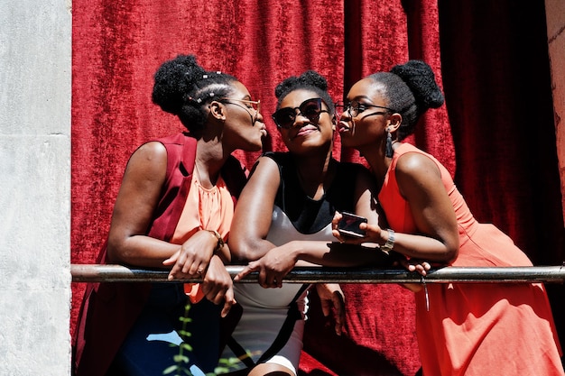 Free photo three stylish african american womans posed at sunny summer day outdoor