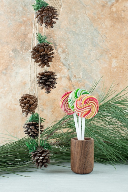 Three sweet colorful lollipops on marble background. High quality photo