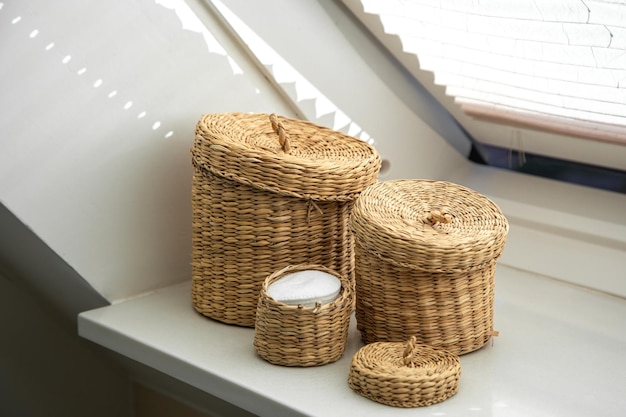 Free photo three wicker boxes for cosmetics and personal care items in the bathroom