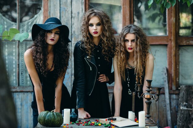Три ведьмы за столом накануне Хэллоуина