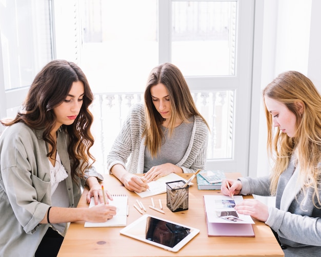 Three women making sketches