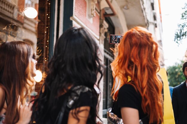 Three women taking selfies