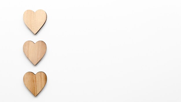 Three wooden hearts on table