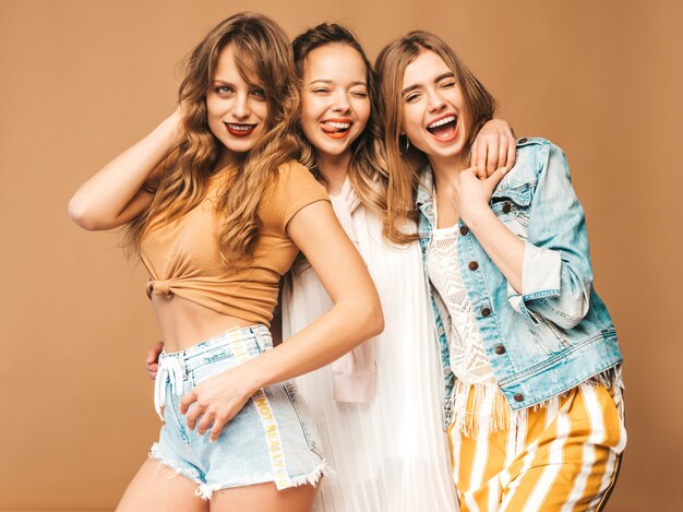 Three young beautiful smiling girls in trendy summer casual clothes. Sexy carefree women posing. Positive models