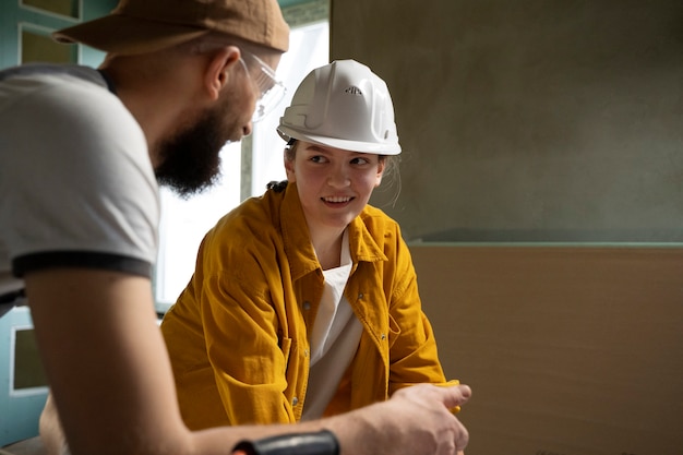 Free photo tiler working on renovation of apartment