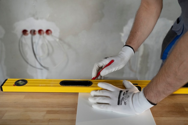 Free photo tiler working on renovation of apartment