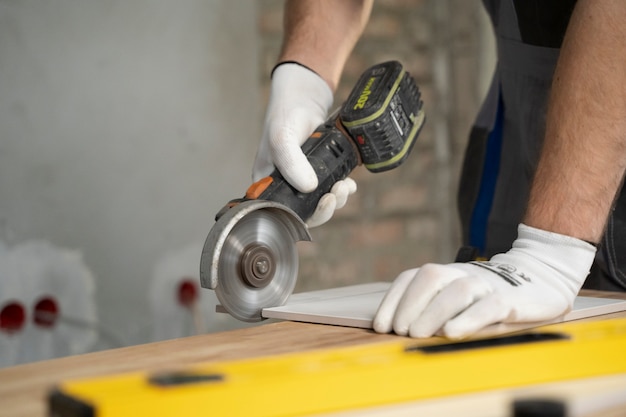 Free photo tiler working on renovation of apartment