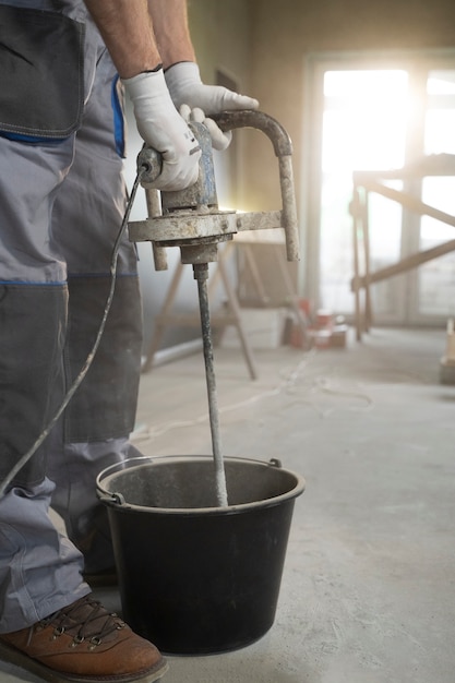 Free photo tiler working on renovation of apartment