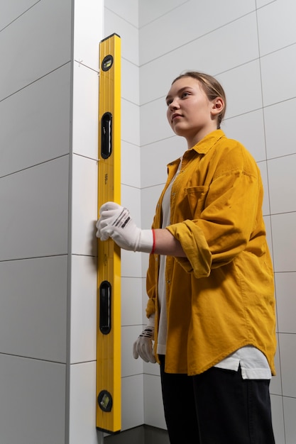 Free photo tiler working on renovation of apartment