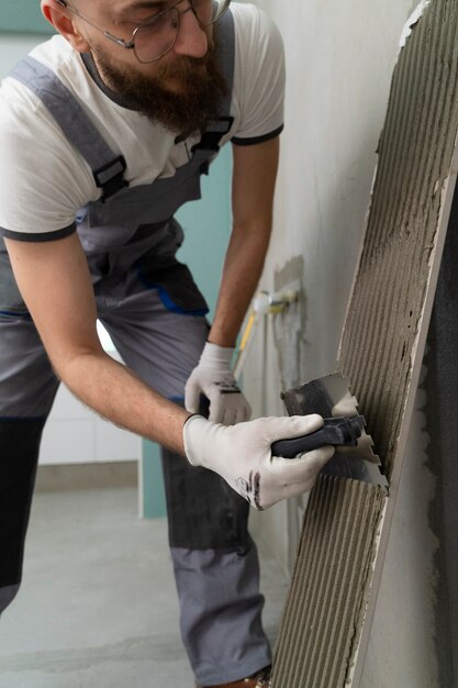 Tiler working on renovation of apartment