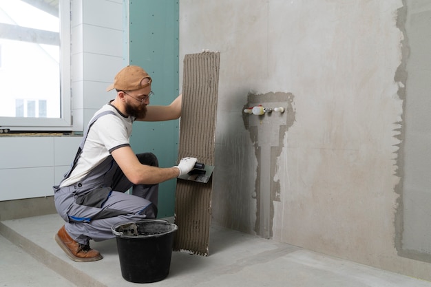 Tiler working on renovation of apartment