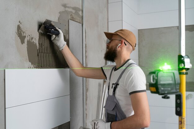 Tiler working on renovation of apartment