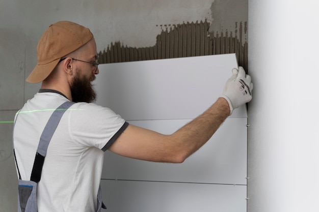 Tiler working on renovation of apartment