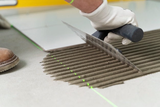 Tiler working on renovation of apartment