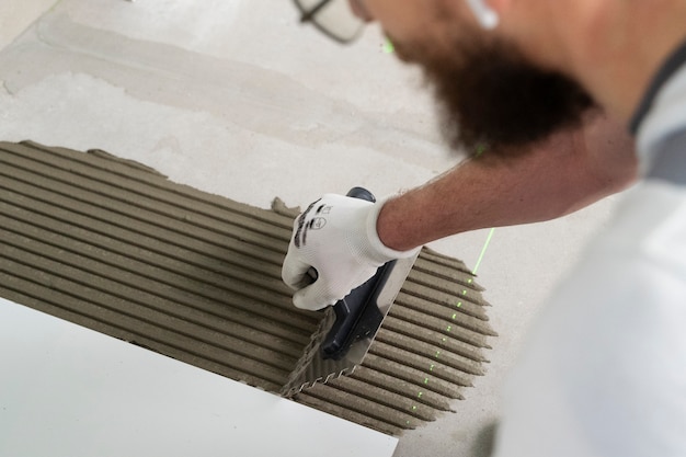 Tiler working on renovation of apartment