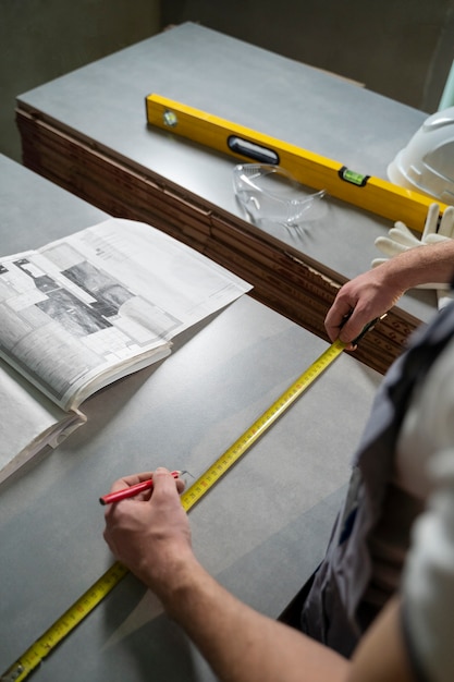 Free photo tiler working on renovation of apartment