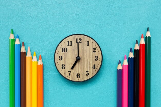 Time back to school with clock and colored pencils