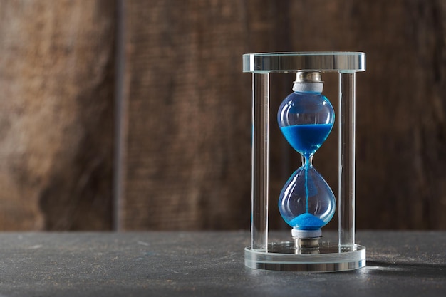 Time is passing blue hourglass close up