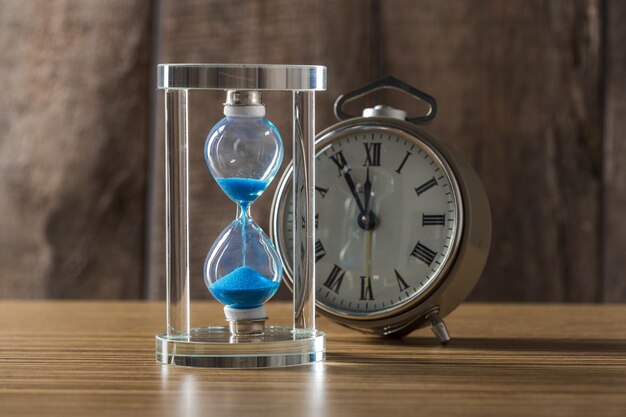 Time is passing. Blue hourglass close up