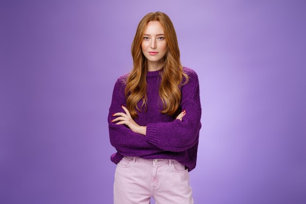 Time manage business. Portrait of confident and ready good-looking redhead female entrepreneur with freckles standing in warm stylish sweater holding hands crossed over chest in assured pose, smiling.