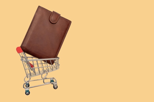 Time for shopping. supermarket trolley with wallet. view from above.