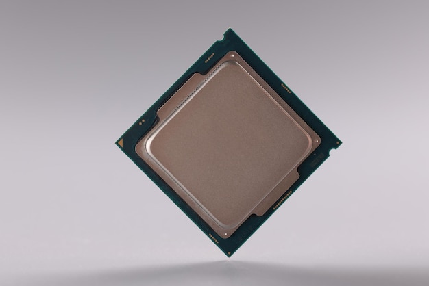 Tiny central processing unit processor chip on grey background