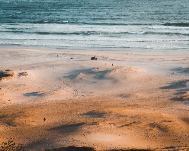 Tiny people enjoying the day at the beach