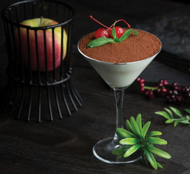 Tiramisu glass with cocoa and berries on the top