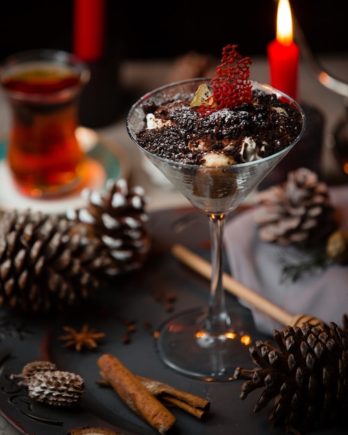 Free photo tiramisu in martini glass served with black tea for christmas table