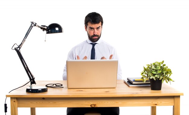 Tired businessman in his office