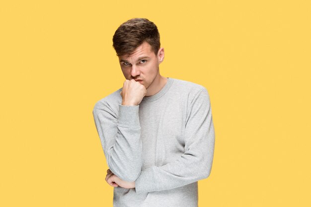 Tired businessman or The serious young man in blue shirt looking at camera over blue studio