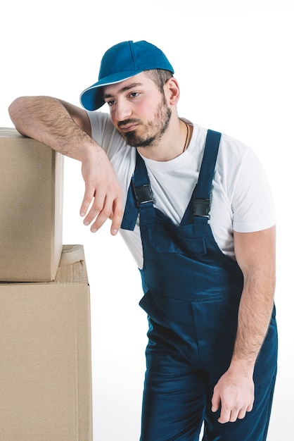 Free photo tired deliveryman near boxes