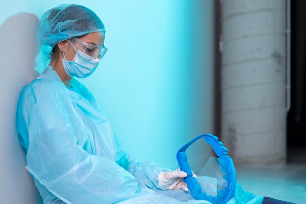 Tired female doctor sitting in the hallway of the hospital