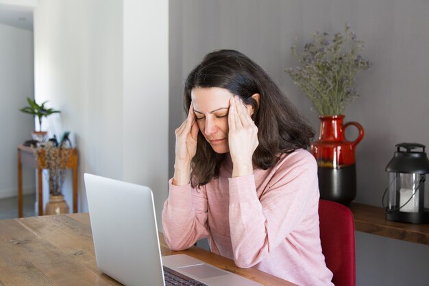 Free photo tired freelancer suffering from headache