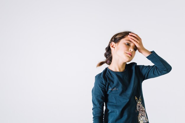 Tired girl touching forehead