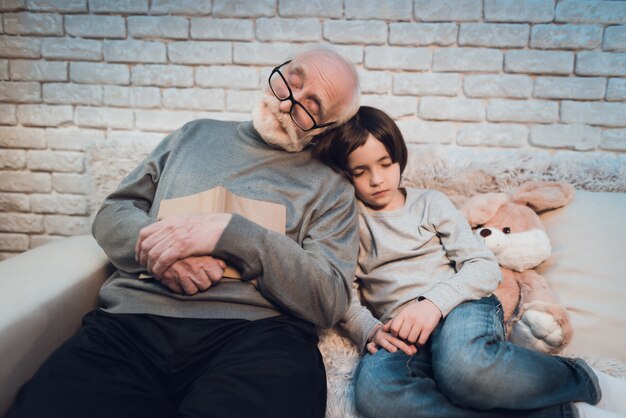 Download Premium Photo Senior Man Grandpa Reads Book For Two Grandkids