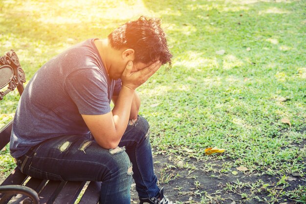 Tired guy covering his face with his hands