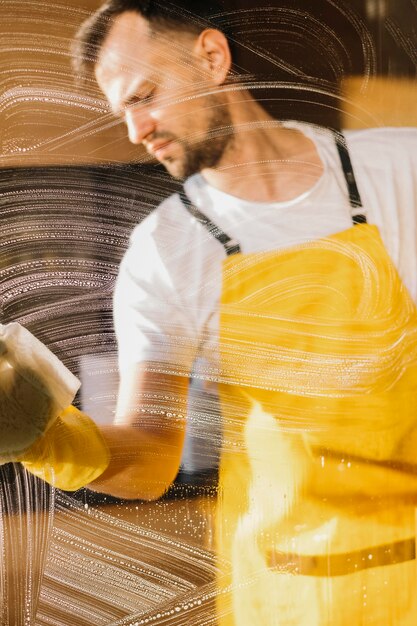 Tired man cleaning window