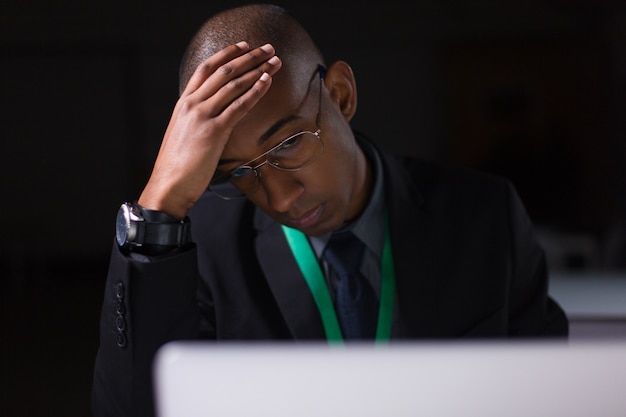 Tired manager working in office late at night