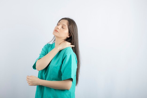 Tired medical worker massaging herself.