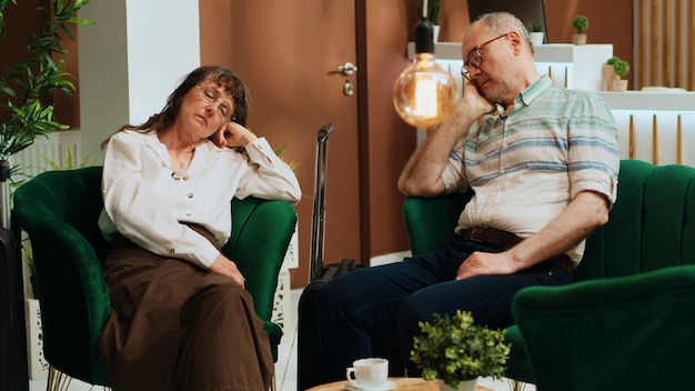 Free photo tired old people falling asleep on sofa